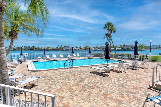 pool featuring fence and a patio