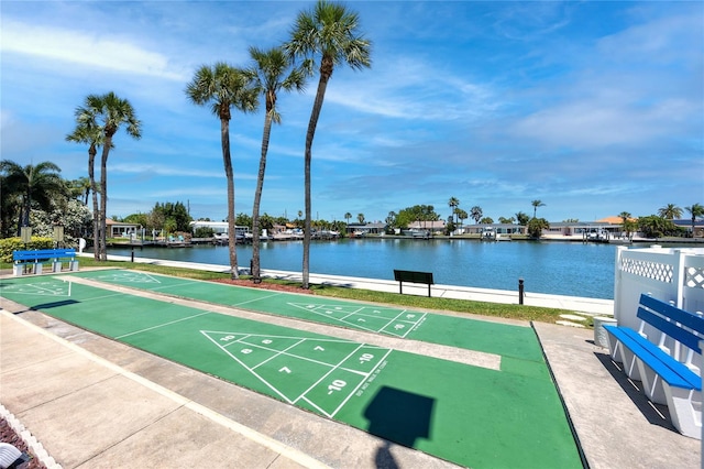 view of community with a water view and shuffleboard