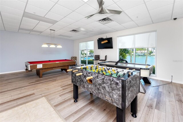 game room with light hardwood / wood-style floors, a paneled ceiling, and billiards