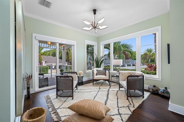 sunroom / solarium with a chandelier