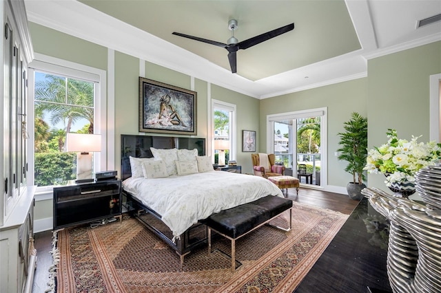 bedroom with dark wood-type flooring, ceiling fan, and crown molding