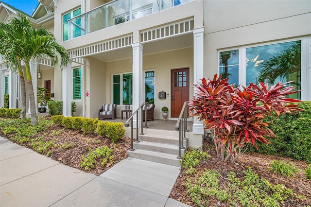 6 Hibiscus Ln, Belleair, FL 33756 - doorway to property with covered porch and stucco siding