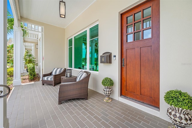 6 Hibiscus Ln, Belleair, FL 33756 - entrance to property with stucco siding and a porch