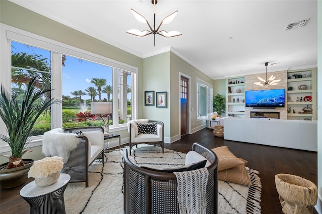 6 Hibiscus Ln, Belleair, FL 33756 - living area with a chandelier, plenty of natural light, wood finished floors, and crown molding