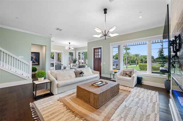 living room featuring an inviting chandelier, crown molding, and hardwood / wood-style flooring