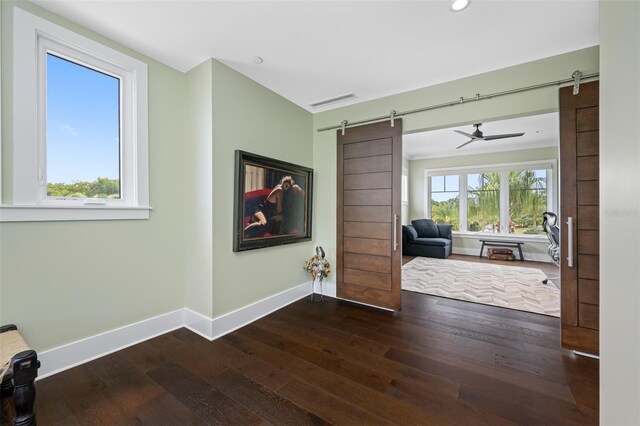 6 Hibiscus Ln, Belleair, FL 33756 - corridor featuring a barn door, baseboards, wood-type flooring, and recessed lighting