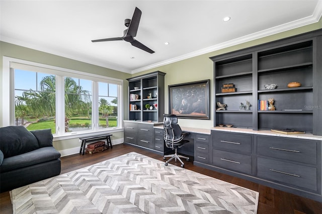 office area featuring crown molding, ceiling fan, dark hardwood / wood-style floors, and built in desk