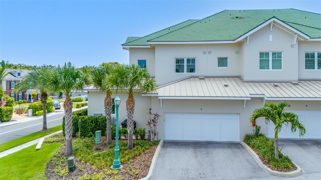 6 Hibiscus Ln, Belleair, FL 33756 - view of property with stucco siding, driveway, and an attached garage