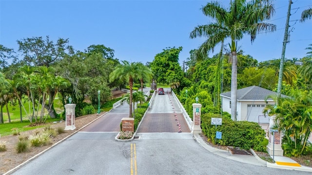 6 Hibiscus Ln, Belleair, FL 33756 - view of asphalt street with curbs and view of wooded area