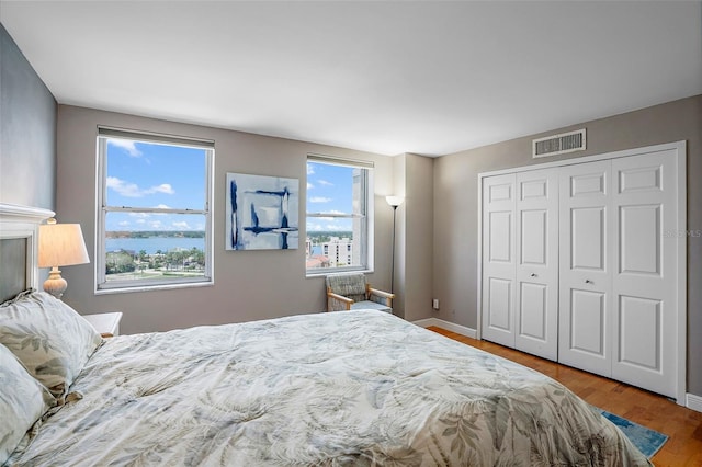 bedroom with a closet and hardwood / wood-style floors