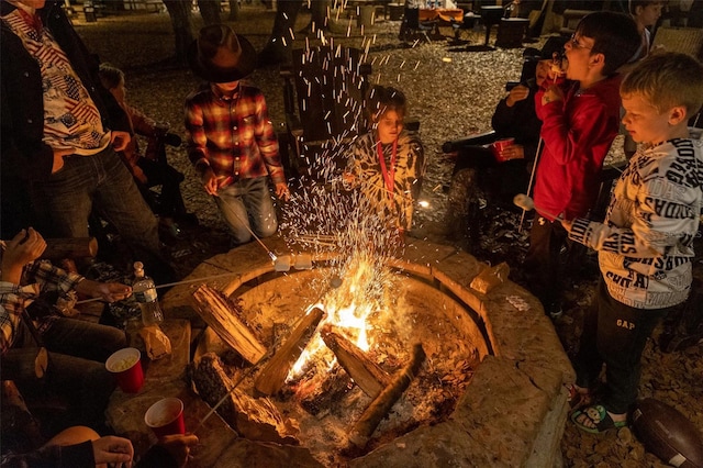 exterior details featuring an outdoor fire pit