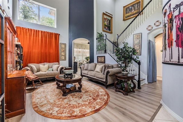 living room with a high ceiling and a wealth of natural light