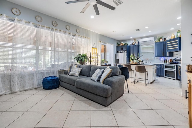 tiled living room featuring sink and ceiling fan