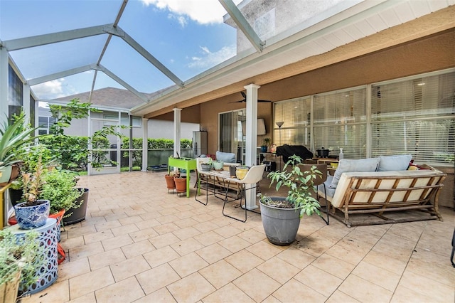 view of patio / terrace with an outdoor living space, a lanai, and ceiling fan