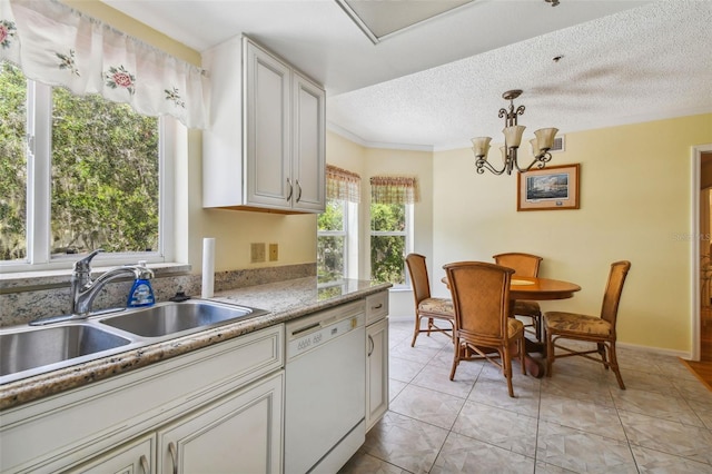 kitchen featuring white dishwasher, sink, white cabinetry, and decorative light fixtures