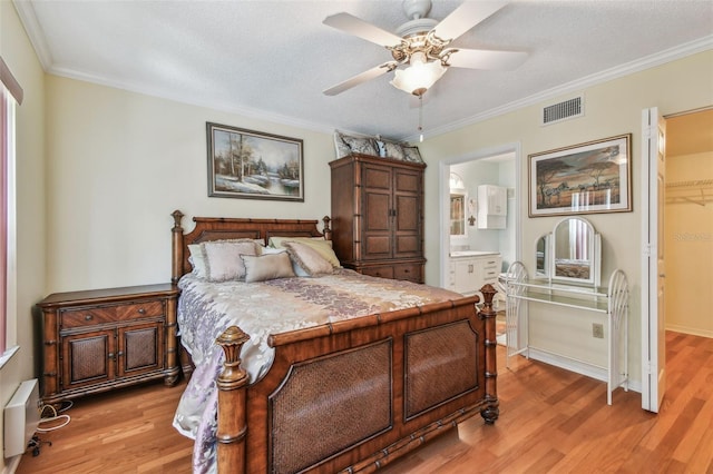 bedroom with ensuite bathroom, crown molding, ceiling fan, and light hardwood / wood-style floors