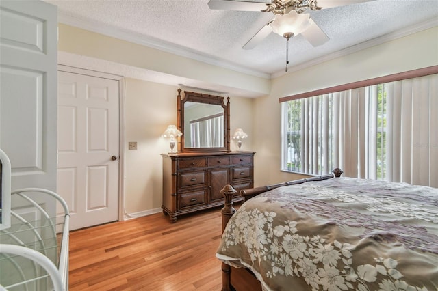 bedroom with crown molding, ceiling fan, light hardwood / wood-style flooring, and a textured ceiling