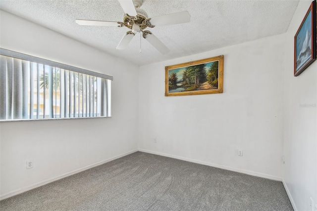 carpeted spare room featuring ceiling fan and a textured ceiling