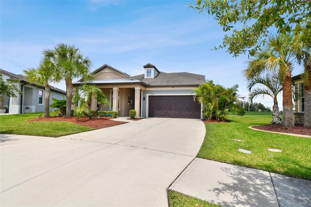 view of front of house featuring a garage and a front lawn