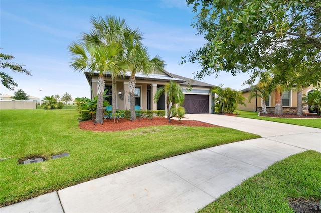 view of front of home with a garage and a front yard