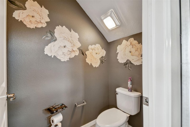 bathroom featuring toilet and vaulted ceiling