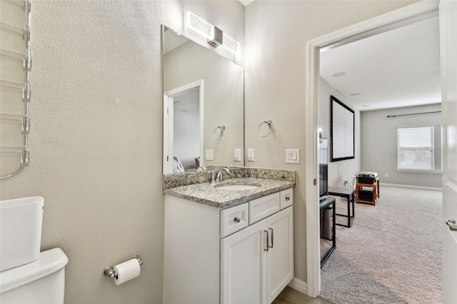 bathroom featuring vanity and toilet