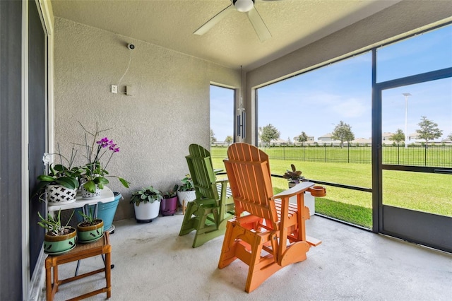 sunroom / solarium featuring ceiling fan and a wealth of natural light