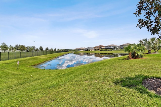 exterior space featuring a water view and a lawn