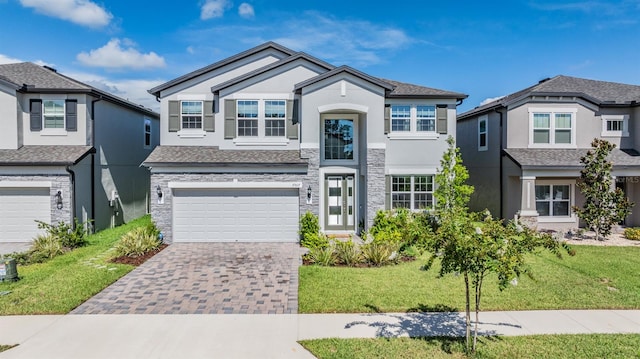 view of front of home with a garage and a front lawn