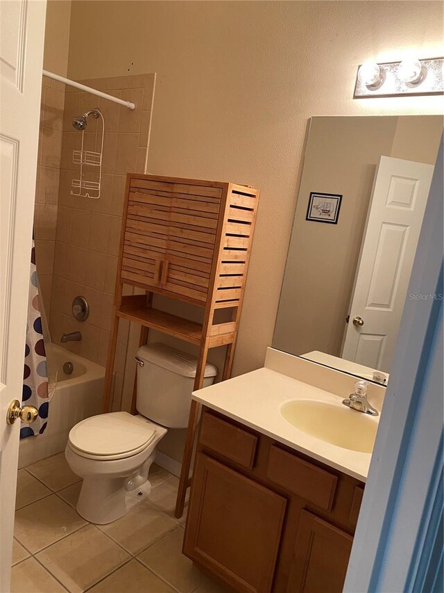 full bath with shower / tub combo with curtain, toilet, vanity, and tile patterned floors