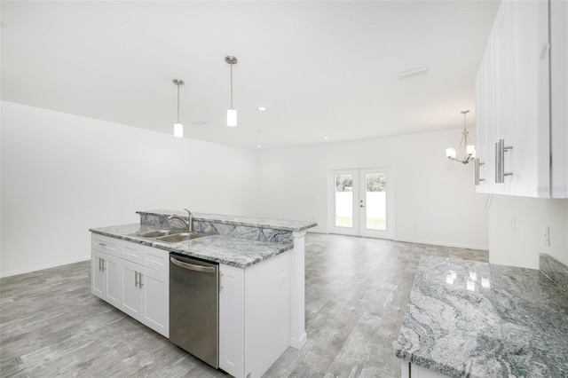 kitchen with an island with sink, sink, white cabinets, hanging light fixtures, and stainless steel dishwasher