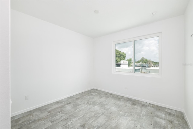 spare room with light hardwood / wood-style flooring