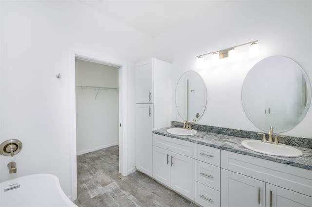 bathroom with vanity and hardwood / wood-style floors