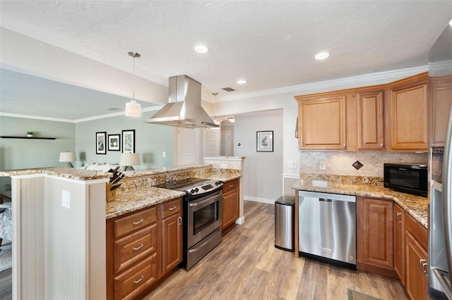 kitchen with light hardwood / wood-style floors, island range hood, stainless steel appliances, hanging light fixtures, and ornamental molding