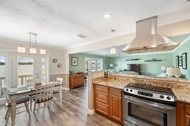 kitchen with electric stove, light stone countertops, island exhaust hood, and pendant lighting