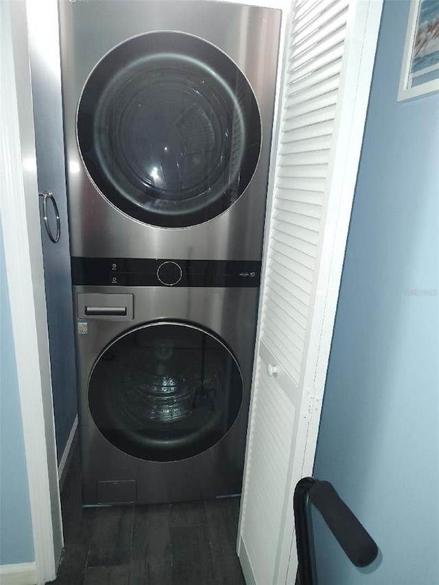 laundry room with stacked washing maching and dryer