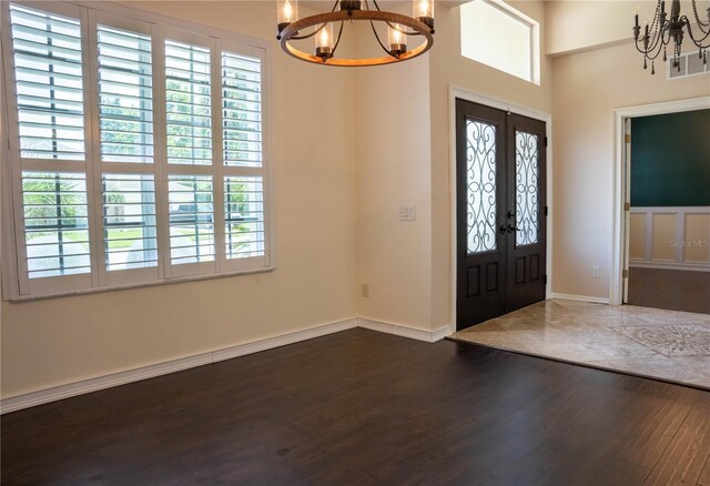 entryway with dark hardwood / wood-style floors and a healthy amount of sunlight