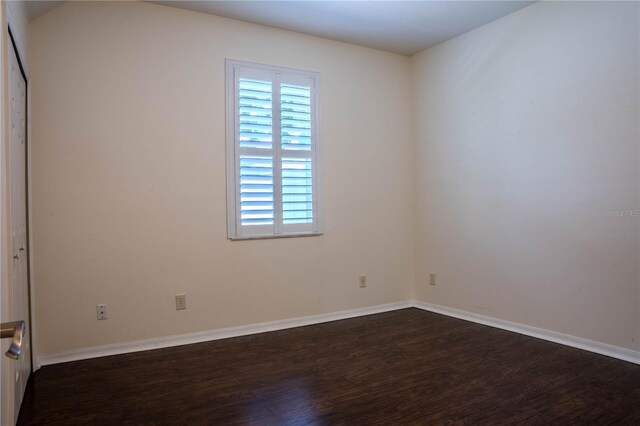 empty room with dark wood-type flooring