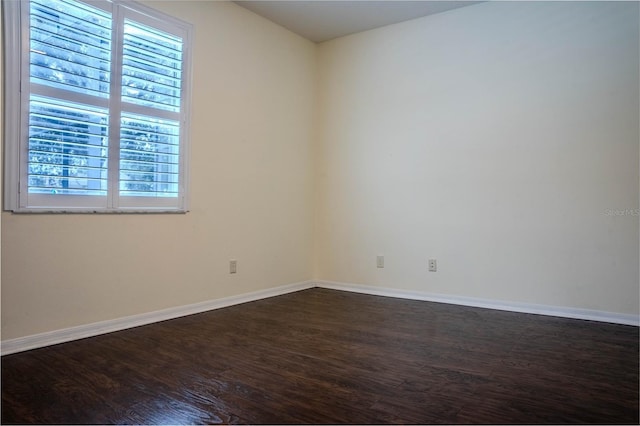 unfurnished room featuring dark wood-type flooring