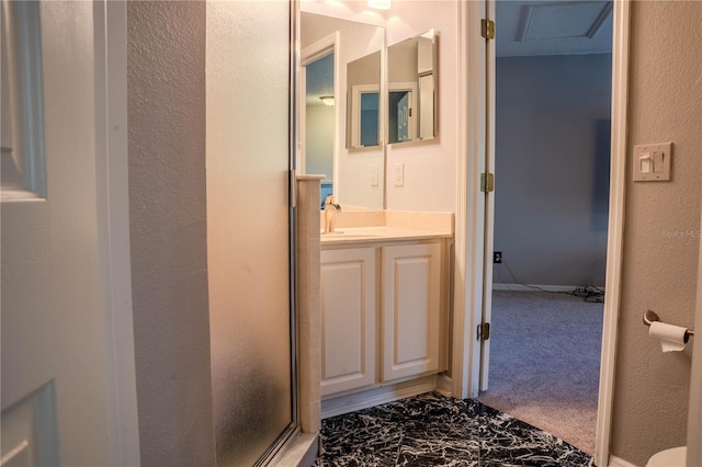 bathroom featuring walk in shower and vanity