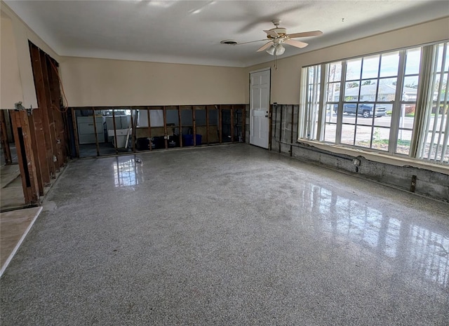 unfurnished living room with ceiling fan