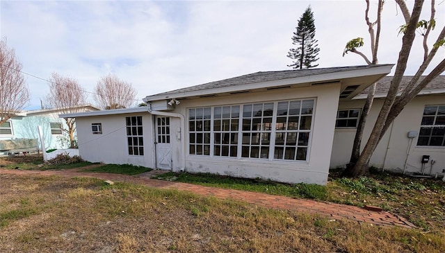 back of property featuring a lawn