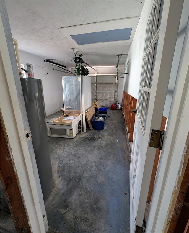 garage featuring stainless steel fridge and a garage door opener