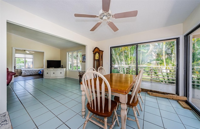 dining room featuring light tile patterned flooring, ceiling fan, vaulted ceiling, and a wealth of natural light