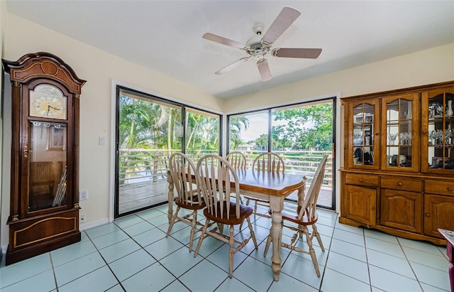 tiled dining space with ceiling fan