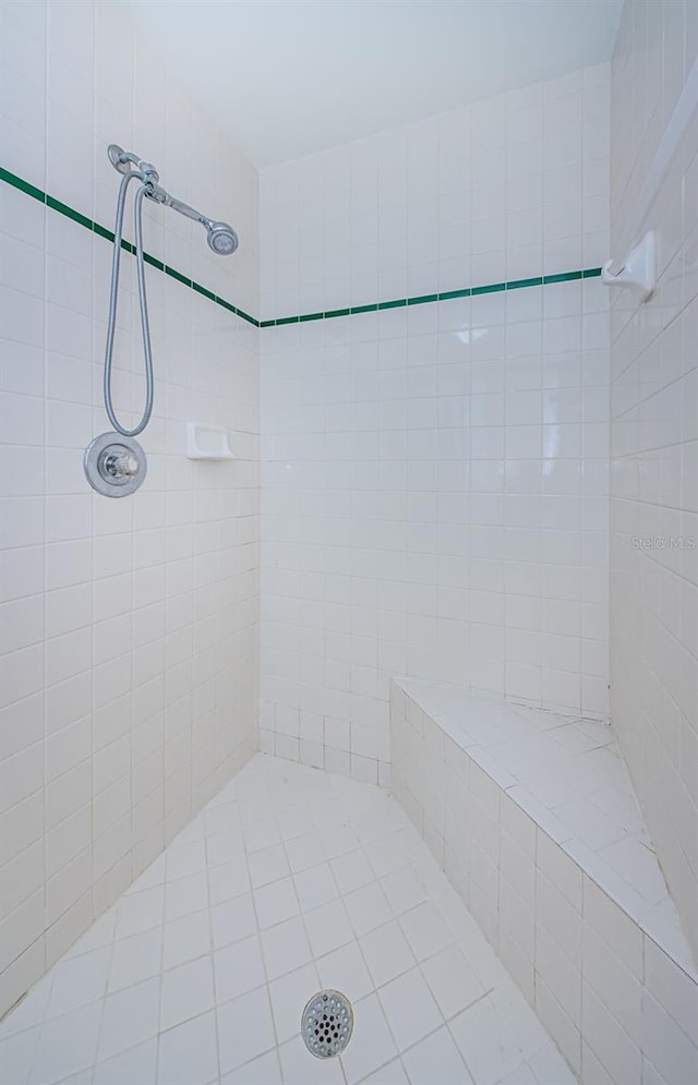 bathroom with tiled shower