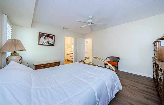 bedroom featuring ceiling fan, dark hardwood / wood-style floors, and ensuite bath