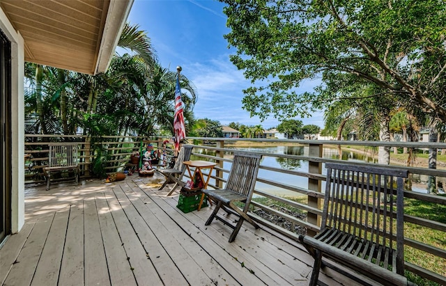 wooden terrace featuring a water view