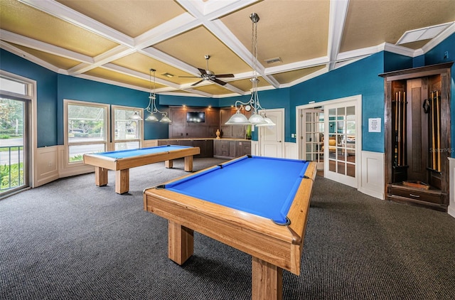 rec room with coffered ceiling, a wealth of natural light, ornamental molding, and carpet flooring