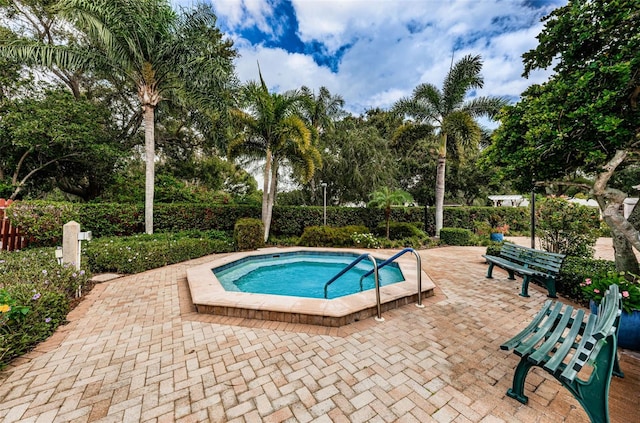 view of pool with a patio and an in ground hot tub